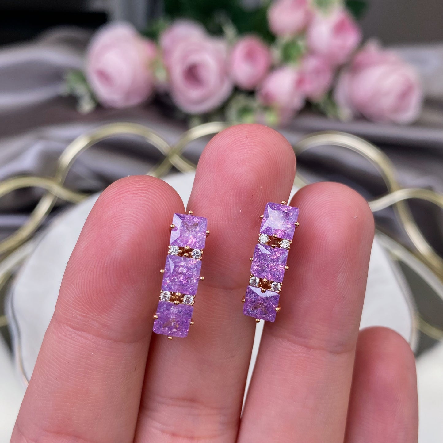 Gold plated earrings with violet decorative crystals